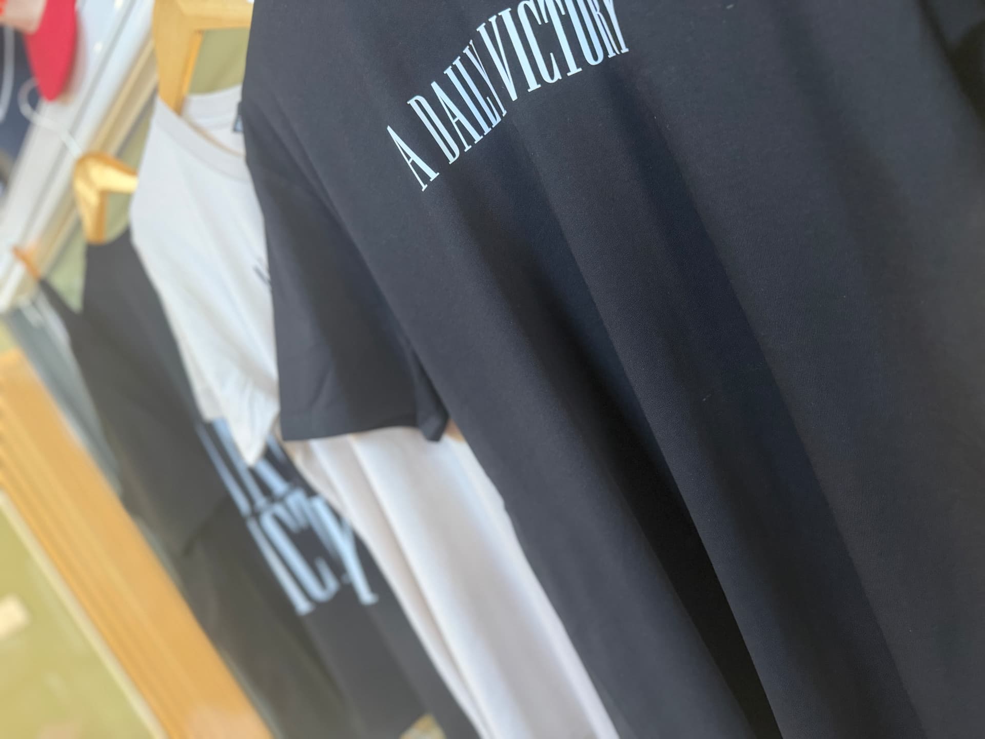 Close-up of a black A Daily Victory T-shirt print